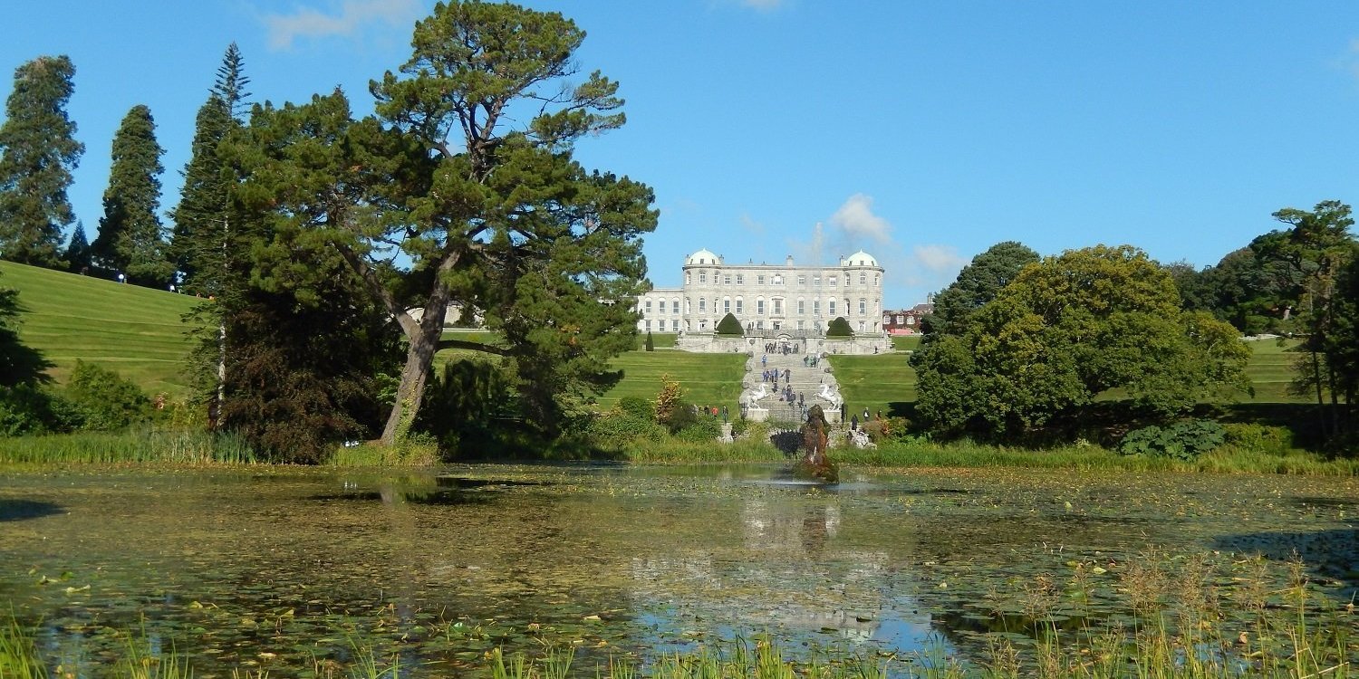 A castle in Irelad with a lake in the front